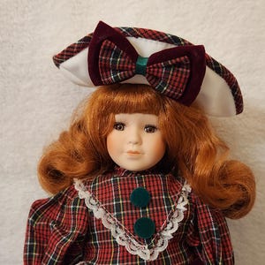 Celebrate the Season Doll with Red Hair with a Red Plaid Dress Porcelain Doll in Red and Green w White Trim Christmas Doll Holiday Décor