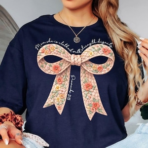 May include: A handmade wooden sign with the text "Welcome" in a playful font. The sign is painted white with a distressed finish, and features a decorative floral design in shades of pink and green. It is designed to be hung on a door or wall.