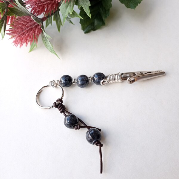 Alligator clip keychain with ceramic beads and leather cord.