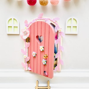 May include: A white ceramic mug with a black handle and the text "But first, coffee" in a black, handwritten-style font. The mug is on a white surface.