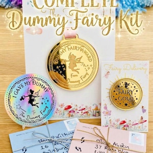 May include: A Complete Dummy Fairy Kit featuring a gold medal with a fairy illustration, a holographic sticker reading I GAVE MY DUMMY TO THE DUMMY FAIRY, a gold coin labeled FAIRY GOLD, and two envelopes tied with metallic string addressed to children.