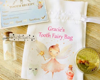 May include: A white tooth fairy bag with a pink and white illustration of a fairy with wings. The bag has the text "Gracie's Tooth Fairy Bag" printed on it. There is a small glass bottle with a white tooth inside, a gold coin, and a tooth fairy receipt.