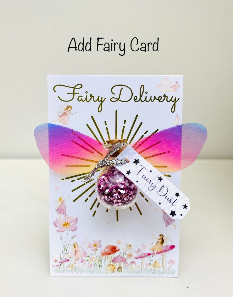May include: A whimsical card with the words "Fairy Delivery" and "Fairy Dust." The card features a small glass bottle filled with pink glitter, adorned with iridescent wings. The words "Add Fairy Card" are at the top.