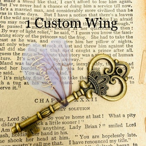 May include: A vintage-style, ornate, gold-toned skeleton key with a decorative crown on the bow. The key is lying on a page of a book with the text "Chapter XXXII" and "Only Solution" visible. The book page is yellowed and has a faded, purple, floral pattern.