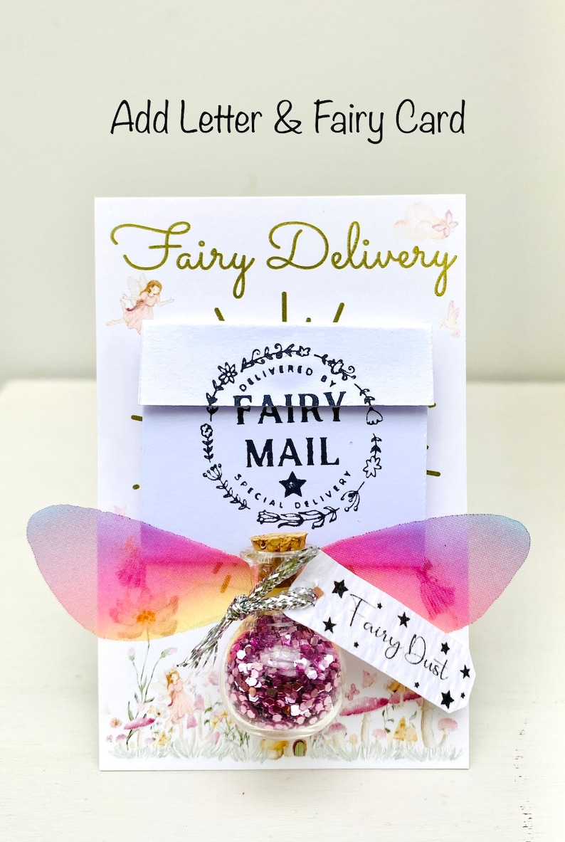 May include: A whimsical Fairy Delivery set with a small glass bottle filled with pink glitter, labeled "Fairy Dust." The set includes a card with "Fairy Delivery" text and fairy illustrations, and decorative fairy wings.