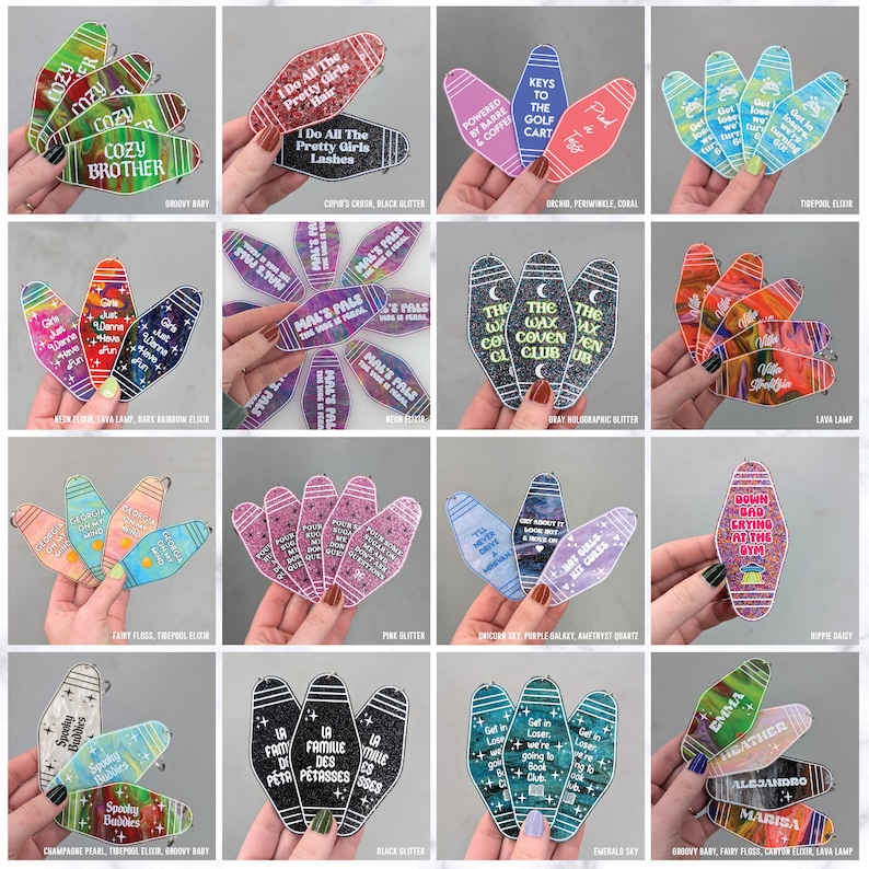May include: A collection of sixteen sets of motel-style keychains featuring various colors, glitter finishes, and printed text. Each keychain has a distinct elongated shape with a hole at the top, displaying phrases like Cozy Brother, The Wax Coven Club, and Emma.
