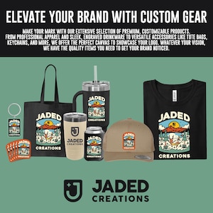 May include: A collection of branded merchandise featuring the Jaded Creations logo, including a black tote bag, a black tumbler with a straw, a beige tumbler, a black can cooler, a tan baseball cap, a keychain, stickers, and a black t-shirt.