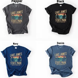four different t-shirt designs featuring the text "Lake James State Park North Carolina" in various colors and styles.