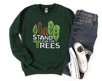 May include: A dark green sweatshirt with a white graphic of trees and the text "Stand for the Trees".