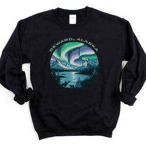May include: Black sweatshirt with a green, blue, and purple aurora borealis design and the text "Seward, Alaska".