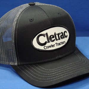 Cletrac Crawler Tractor Logo On A Black And Charcoal Mesh Trucker Hat Snapback