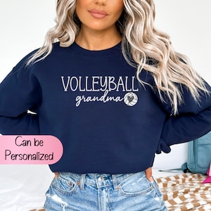 May include: Navy blue sweatshirt with the text "VOLLEYBALL grandma" and a white volleyball with a black heart in the center.