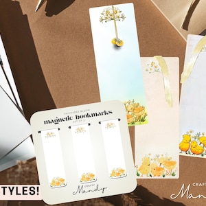 May include: A selection of Chickadee Bloom magnetic bookmarks with different designs. The bookmarks display illustrations of yellow chicks, flowers, and the text "5 STYLES!". The Crafty Mandy logo is also visible.