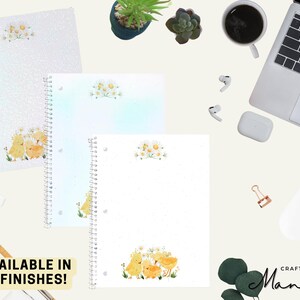 May include: Spiral-bound notebooks featuring a floral and chick design. The notebooks come in various finishes, with a watercolour illustration of yellow chicks and daisies. The text "AVAILABLE IN 5 FINISHES!" is visible.