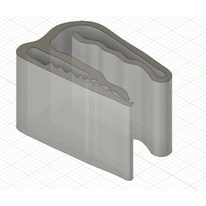 May include: A 3D-rendered, grey plastic clip with a curved top and a wavy interior design. The clip has a rectangular base and a slot on one side. The background is a grid.