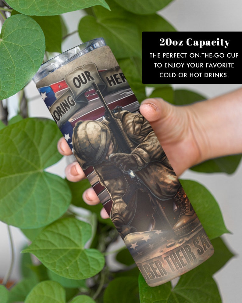 May include: A 20-ounce stainless steel tumbler with a patriotic design. It features a soldier kneeling in front of an American flag with the words "Honoring Our Heroes" and "Remember Their Sacrifice".