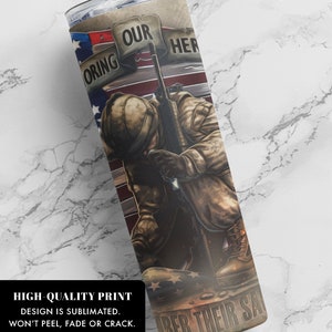 May include: A stainless steel tumbler with a design of a soldier kneeling with a rifle, an American flag, and the text "Honoring Our Heroes Remember Their Sacrifice".
