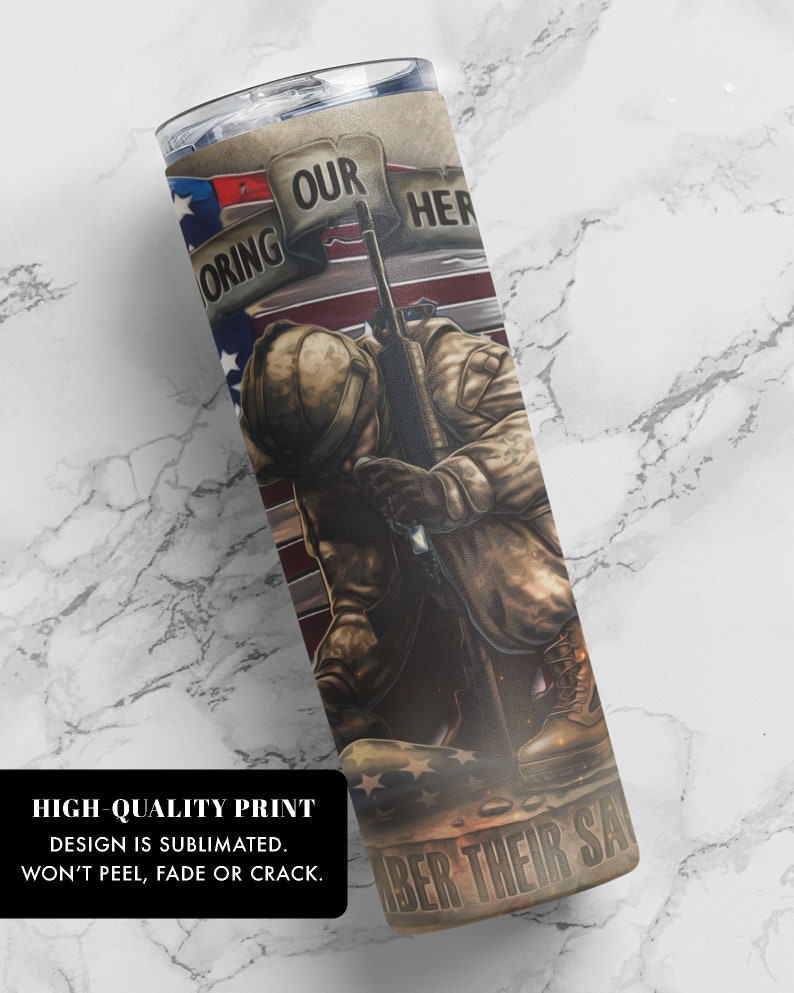 May include: A stainless steel tumbler with a design of a soldier kneeling with a rifle, an American flag, and the text "Honoring Our Heroes Remember Their Sacrifice".