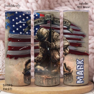 May include: A patriotic tumbler with a distressed American flag design, a soldier kneeling and a helmet, and the text "Honoring Our Heroes" and "Remember Their Sacrifice". The tumbler is personalized with the name "Mark".
