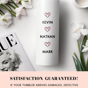May include: White stainless steel tumbler with three names, Kevin, Nathan, and Mark, written in black text. Each name is accompanied by a black heart with a red baseball graphic inside.