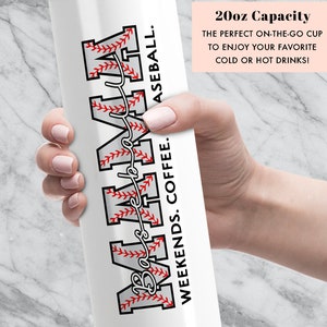 May include: White stainless steel tumbler with a baseball-themed design. The tumbler features the word "MAMA" with a baseball stitch pattern and the text "Weekends. Coffee. Baseball." The tumbler has a 20oz capacity.