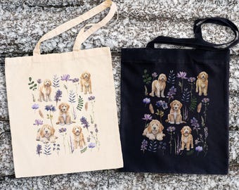 May include: Two tote bags with a floral pattern featuring doodle dogs. One bag is beige and the other is black.