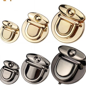 May include: Two sets of gold and black metal purse clasps. Each set includes three different sizes of clasps.