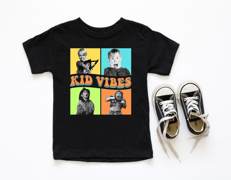 May include: Black t-shirt with a graphic of four images of a young boy in different poses. The images are in colorful frames with the text "KID VIBES" in a retro font.