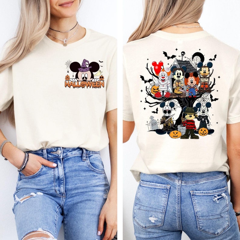 May include: A white t-shirt with a Mickey Mouse Halloween design on the front and a Halloween-themed Mickey Mouse and horror character design on the back. The shirt is being worn by a person with blue jeans.