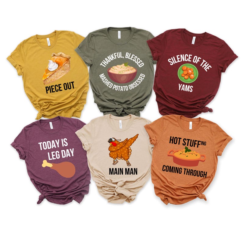 Op de afbeelding: Zes verschillende Thanksgiving-thema t-shirts. De shirts zijn allemaal met korte mouwen en hebben verschillende Thanksgiving-gerelateerde ontwerpen en tekst, waaronder "Piece Out", "Thankful, Blessed, Mashed Potato Obsessed", "Silence of the Yams", "Today is Leg Day", "Main Man" en "Hot Stuffing Coming Through".