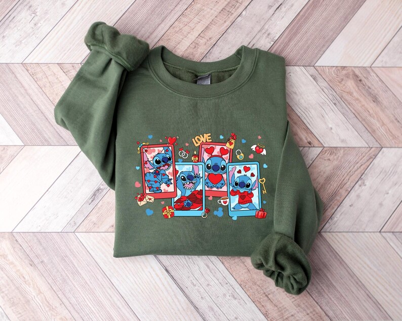 May include: Green sweatshirt with a graphic print of Stitch from Lilo & Stitch. The print features Stitch in four different poses with hearts and the word "LOVE".
