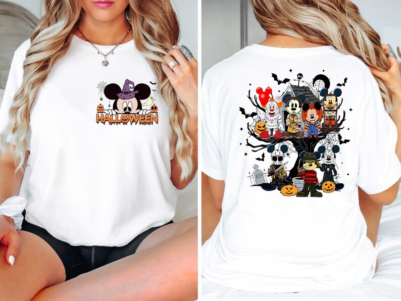 May include: White t-shirt with a Halloween themed graphic featuring Mickey Mouse and other characters. The front of the shirt features Mickey Mouse in a witch's hat with the word "HALLOWEEN" underneath. The back of the shirt features Mickey Mouse and other characters in a spooky tree with pumpkins and bats.