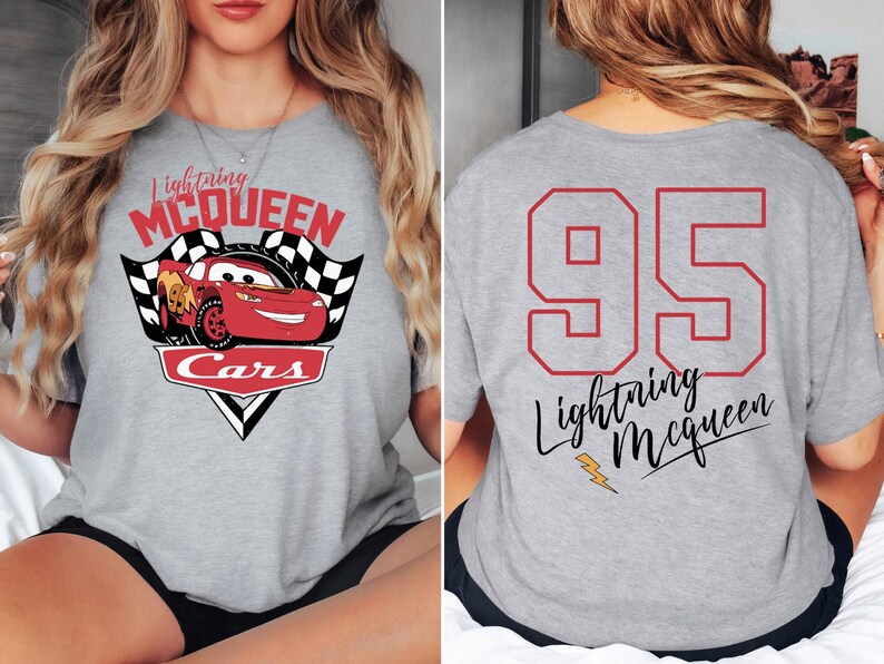May include: Grey t-shirt with a red race car graphic and the text "Lightning McQueen Cars" on the front. The back of the shirt has the number "95" in red and the text "Lightning McQueen" in black.