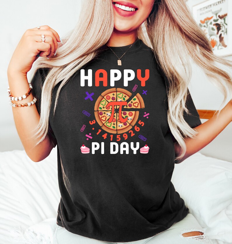 May include: Black t-shirt with a graphic of a pizza slice with the mathematical symbol pi and the text "Happy Pi Day".