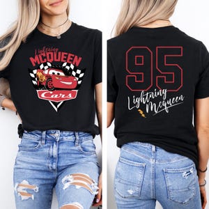 May include: Black t-shirt with a red Lightning McQueen Cars graphic on the front and the number 95 with "Lightning McQueen" text on the back.