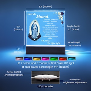 May include: A lighted acrylic plaque with a blue background and a wooden base. The plaque features an image of the Virgin Mary and Spanish text that reads "Querida Mam&aacute;". The plaque is 5.9 inches (150mm) wide and 5.3 inches (135mm) tall.