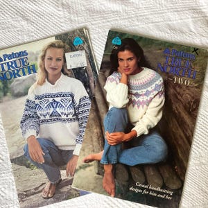 May include: Two vintage knitting pattern books titled "Patons True North" are displayed. The covers feature women wearing knitted sweaters with geometric patterns in blue, white, and purple. The text "Casual handknitting designs for him and her" is visible.