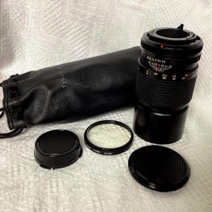 RMC Tokina 200mm f/3.5 Lens, with Cannon FD mount, lens made in Japan, vintage 1980s, 6 inch in length, with original Tokina soft pouch, both cover caps.