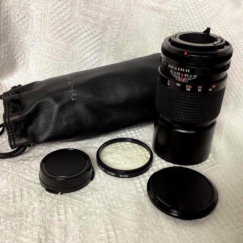 RMC Tokina 200mm f/3.5 Lens, with Cannon FD mount, lens made in Japan, vintage 1980s, 6 inch in length, with original Tokina soft pouch, both cover caps.