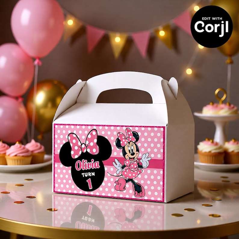 May include: White party favor box with a pink polka dot design and Minnie Mouse graphics. The box features a large Minnie Mouse head with the name "Olivia" and the number "1". Pink balloons and cupcakes are in the background.