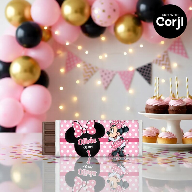 May include: A chocolate bar with a pink and white polka dot wrapper featuring a Minnie Mouse design. The wrapper includes the name "Olivia" and the number "1". The background includes balloons and cupcakes.