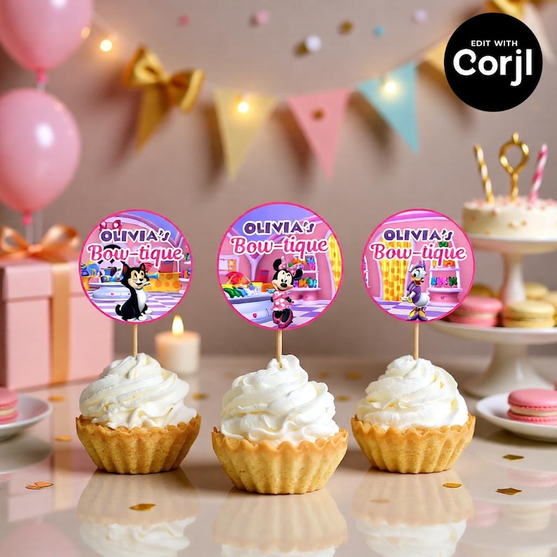 May include: Three cupcakes topped with white frosting and decorative toppers. The toppers are pink circles with the text "OLIVIA'S Bow-tique" and cartoon characters. The cupcakes sit on a table with party decorations.