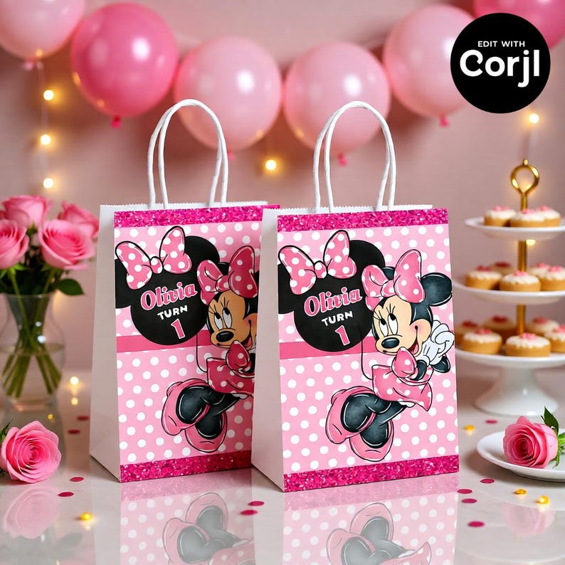 May include: Two white paper gift bags with pink polka dots and a Minnie Mouse design. Each bag features the name "Olivia" and the number "1". The bags have white handles and a pink glitter border. Pink balloons and roses are in the background.