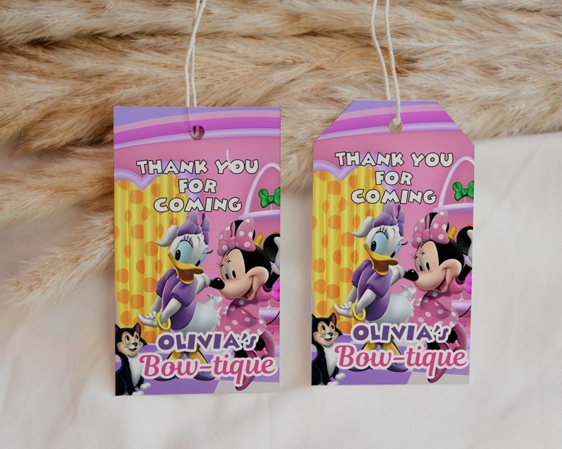 May include: Two pink and purple gift tags with the text "THANK YOU FOR COMING" and "OLIVIA'S Bow-tique". The tags feature cartoon images of Daisy Duck, Minnie Mouse, and a black cat.