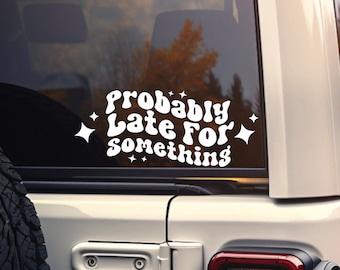 May include: White vinyl sticker with the text "Probably Late For Something" in a retro font with stars on a white car window.