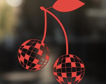 May include: Two red cherries with a disco ball design. The cherries are connected by a stem and have a green leaf.