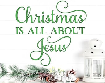 May include: White wooden mantel with a green Christmas sign that reads "Christmas is all about Jesus". The mantel is decorated with a pine branch, pinecones, and white berries.