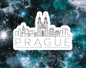 May include: A white sticker with a black outline of the Prague skyline, including the iconic Church of Our Lady Before Týn. The text "PRAGUE" is written below the skyline.
