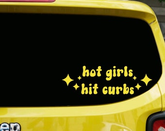 May include: Yellow vinyl decal with the text "hot girls hit curbs" and four small stars on a black background. The decal is on the back window of a yellow car.
