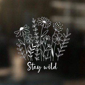 May include: Black and white line art illustration of a bouquet of wildflowers with the text "Stay wild" below.